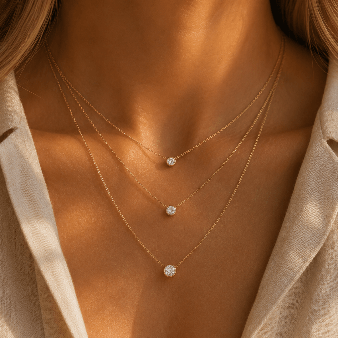 14k gold diamond solitaire necklaces layered in three diamond sizes